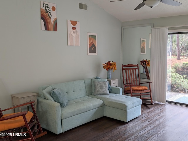 living room featuring lofted ceiling, hardwood / wood-style floors, and ceiling fan