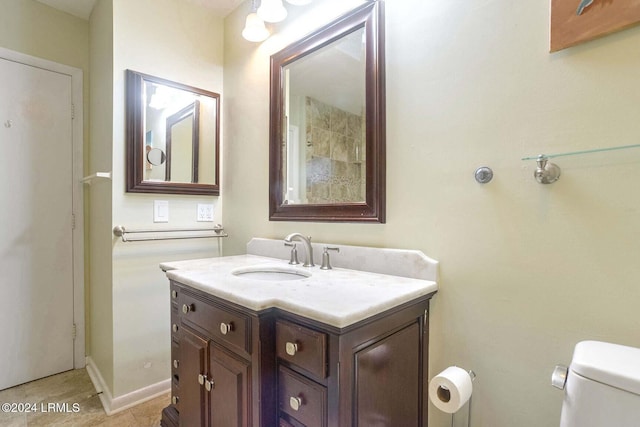 bathroom featuring vanity, tile patterned flooring, and toilet