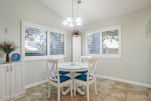 dining area featuring lofted ceiling, plenty of natural light, and a chandelier