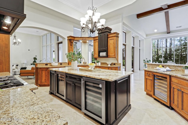 kitchen featuring wine cooler, a notable chandelier, and arched walkways