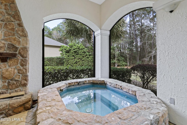 view of pool with an in ground hot tub