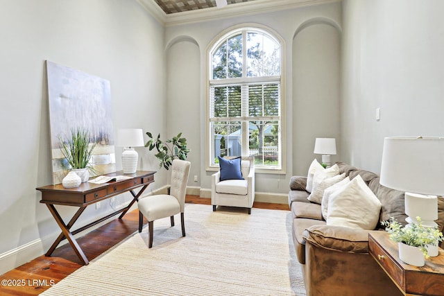 office area with crown molding, baseboards, and wood finished floors