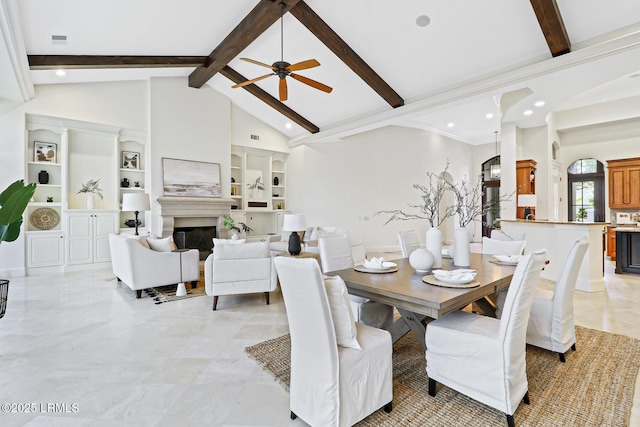 dining space featuring visible vents, beamed ceiling, a fireplace, and ceiling fan