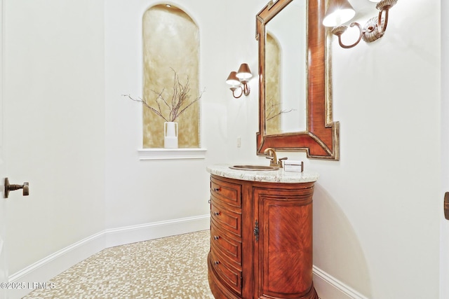 bathroom with vanity and baseboards