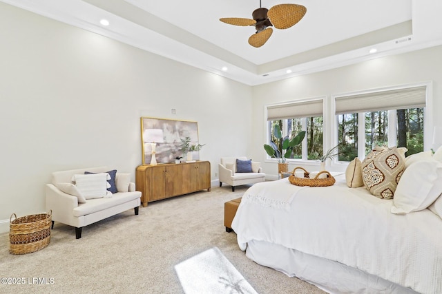 carpeted bedroom with baseboards, visible vents, recessed lighting, ceiling fan, and a raised ceiling