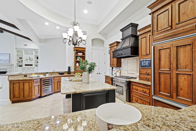 kitchen featuring crown molding, wine cooler, built in appliances, custom range hood, and light stone counters