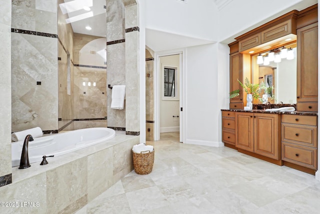 bathroom with vanity, a garden tub, baseboards, and tiled shower