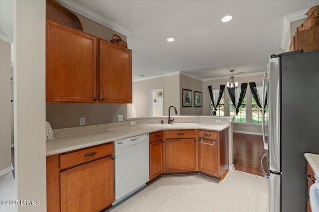 52 Summerplace Dr, Bluffton, SC 29909 - kitchen with freestanding refrigerator, dishwasher, a sink, a chandelier, and a peninsula