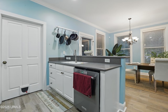 89 Bostick Cir, Beaufort, SC 29902 - kitchen with stainless steel dishwasher, a sink, dark countertops, white cabinetry, and crown molding