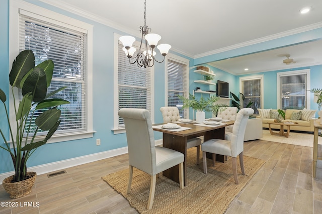 89 Bostick Cir, Beaufort, SC 29902 - dining room with light wood finished floors, a chandelier, baseboards, crown molding, and recessed lighting