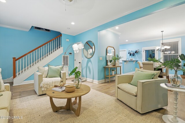 89 Bostick Cir, Beaufort, SC 29902 - living area with wood finished floors, ornamental molding, stairway, a chandelier, and recessed lighting