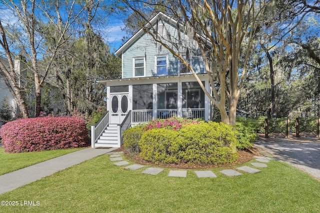 89 Bostick Cir, Beaufort, SC 29902 - view of front facade featuring a sunroom, a front yard, and stairway