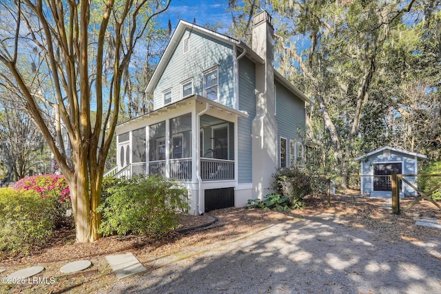 89 Bostick Cir, Beaufort, SC 29902 - view of side of home featuring a sunroom and a chimney