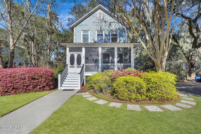 89 Bostick Cir, Beaufort, SC 29902 - view of front of house with a sunroom, a front lawn, and stairway