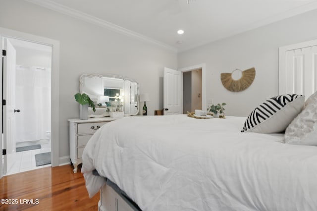 89 Bostick Cir, Beaufort, SC 29902 - bedroom with wood finished floors, ornamental molding, recessed lighting, ensuite bath, and baseboards