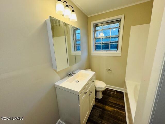 1154 Spruce St, Allendale, SC 29810 - bathroom featuring toilet, ornamental molding, a bath, vanity, and hardwood / wood-style flooring