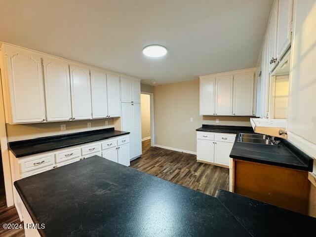 1154 Spruce St, Allendale, SC 29810 - kitchen featuring white cabinetry, dark hardwood / wood-style flooring, and sink