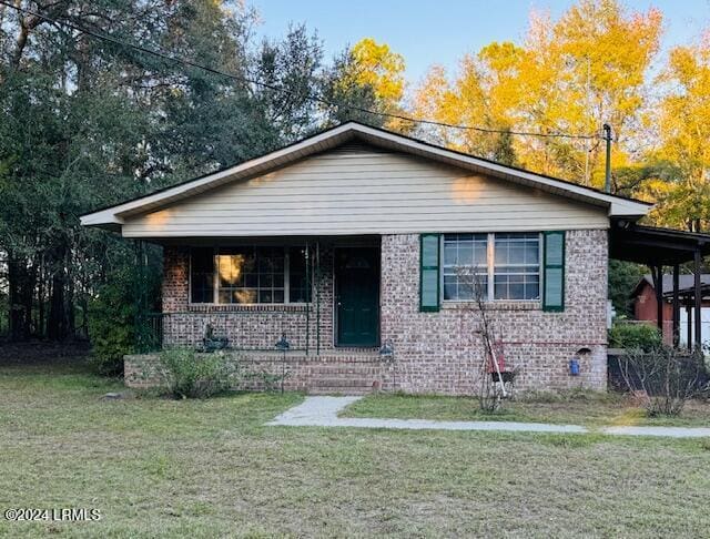 bungalow-style home with a front yard