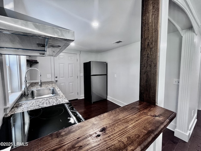 193 Paige Point Rd, Seabrook, SC 29940 - kitchen with freestanding refrigerator, exhaust hood, and range with electric stovetop