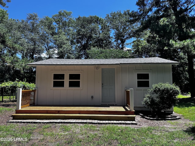 193 Paige Point Rd, Seabrook, SC 29940 - view of front facade featuring board and batten siding, roof with shingles, and an outdoor structure