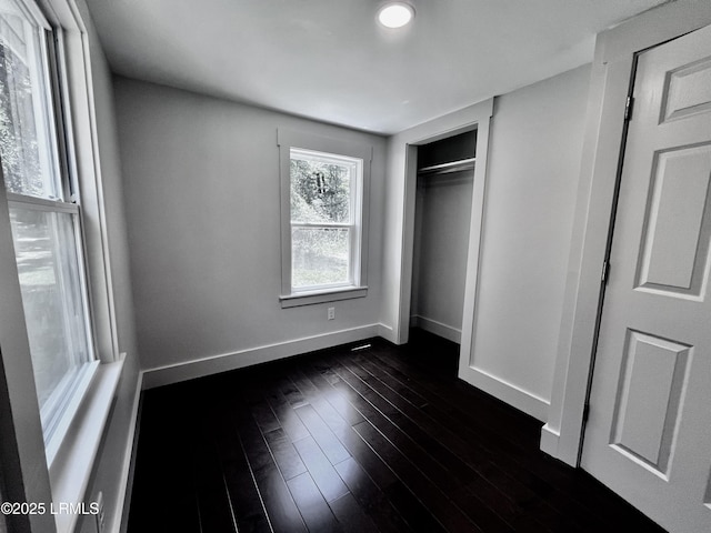 193 Paige Point Rd, Seabrook, SC 29940 - unfurnished bedroom featuring dark wood-style floors and a closet