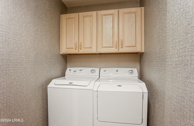 washroom with cabinets and separate washer and dryer