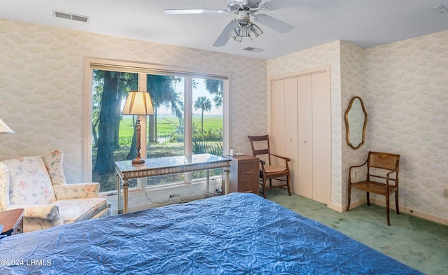 bedroom with carpet flooring, ceiling fan, and a closet