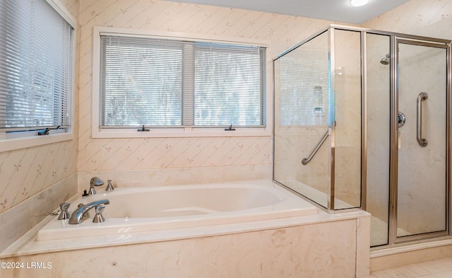 bathroom with shower with separate bathtub and a healthy amount of sunlight