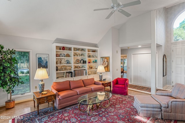 living room featuring hardwood / wood-style flooring, ceiling fan, a healthy amount of sunlight, and high vaulted ceiling