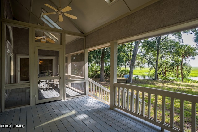 unfurnished sunroom featuring lofted ceiling and ceiling fan