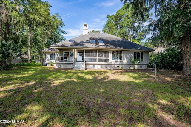 back of property with a porch and a lawn