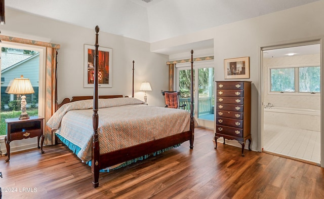 bedroom featuring multiple windows, access to exterior, connected bathroom, and hardwood / wood-style floors