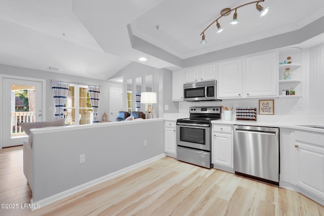 kitchen featuring appliances with stainless steel finishes, kitchen peninsula, and white cabinets