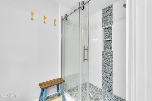 bathroom featuring a shower with shower door