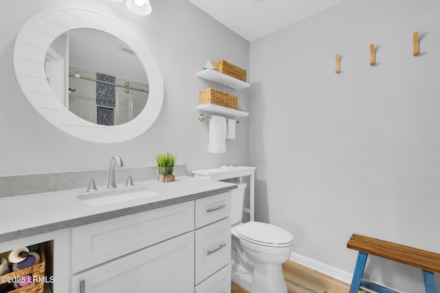 bathroom with wood-type flooring, vanity, and toilet