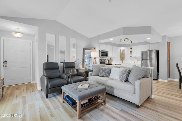 living room with vaulted ceiling and light wood-type flooring