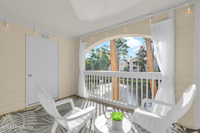 sunroom / solarium featuring a water view and a healthy amount of sunlight