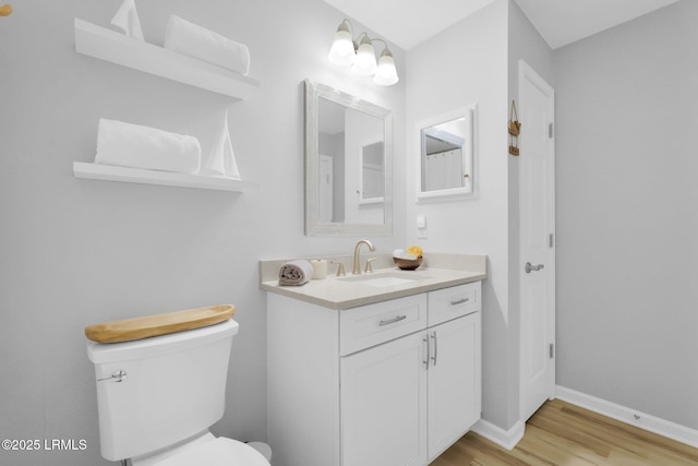 bathroom with vanity, hardwood / wood-style flooring, and toilet