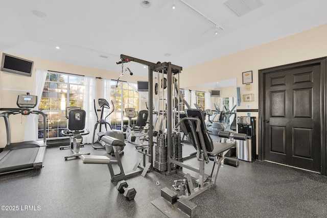 exercise room featuring rail lighting