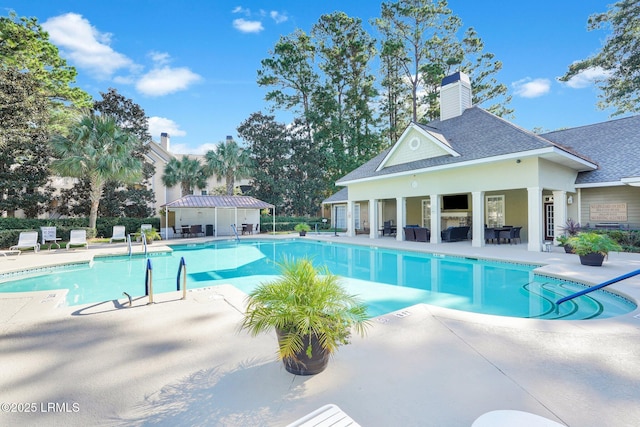 view of pool with an outbuilding and a patio