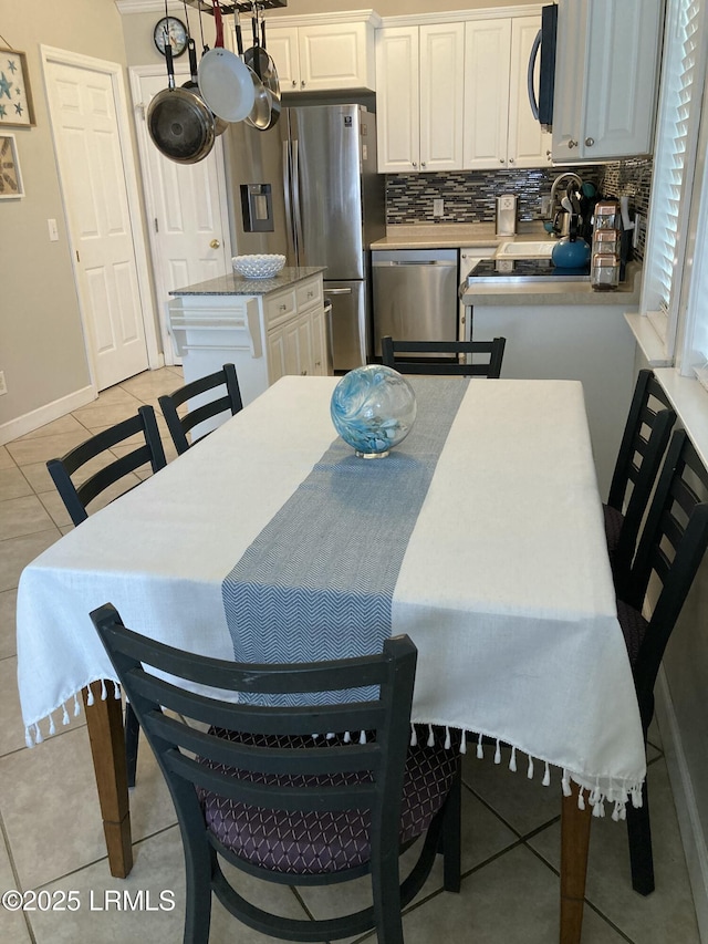 dining area featuring light tile patterned flooring