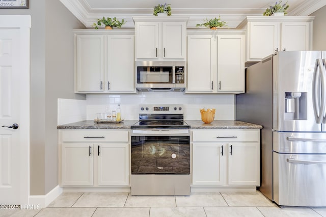 kitchen with stainless steel appliances, ornamental molding, tasteful backsplash, and white cabinets