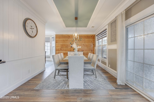 dining area with crown molding, a tray ceiling, and dark hardwood / wood-style floors