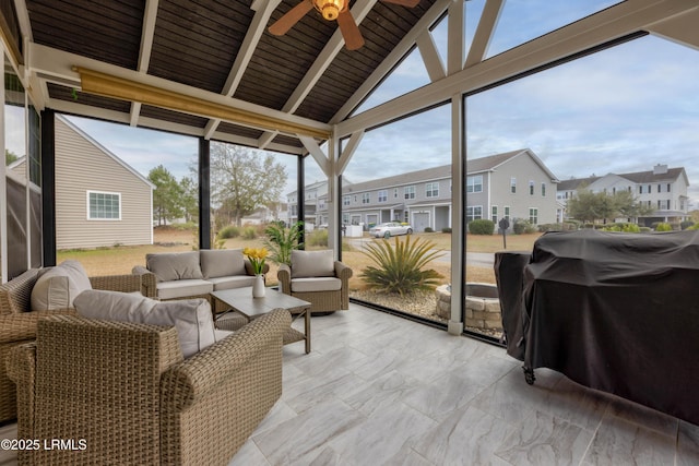 sunroom with ceiling fan and lofted ceiling