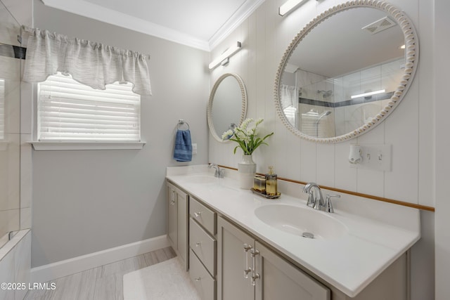 bathroom with vanity, a shower with door, and ornamental molding