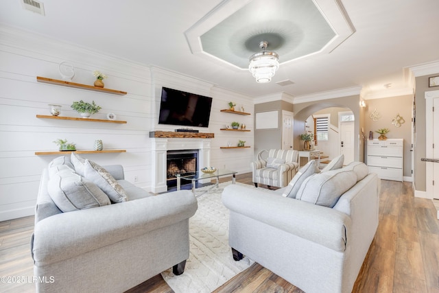 living room featuring crown molding and light wood-type flooring