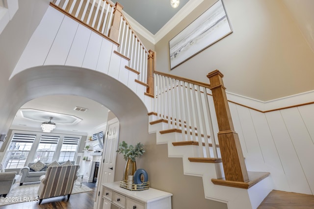 staircase featuring crown molding