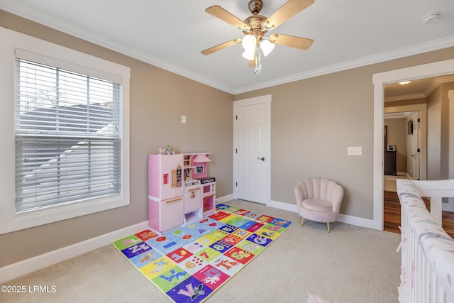 game room with carpet floors, ornamental molding, and ceiling fan