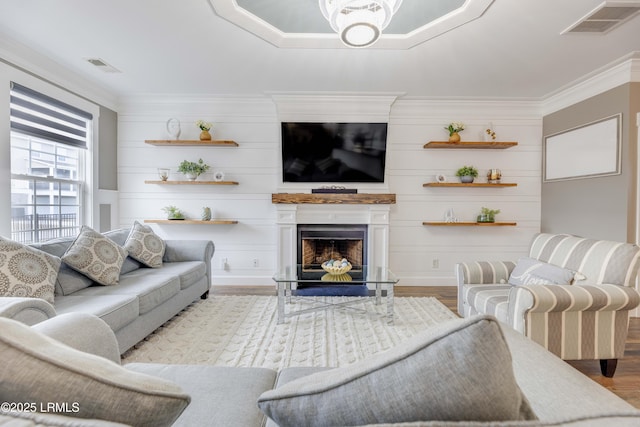 living room with crown molding and light hardwood / wood-style floors