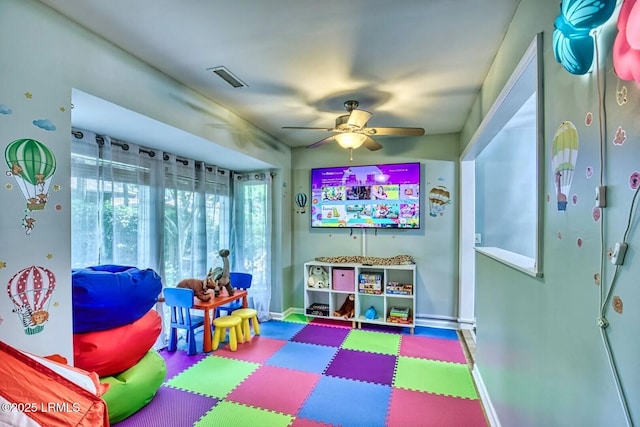 playroom featuring ceiling fan, visible vents, and baseboards